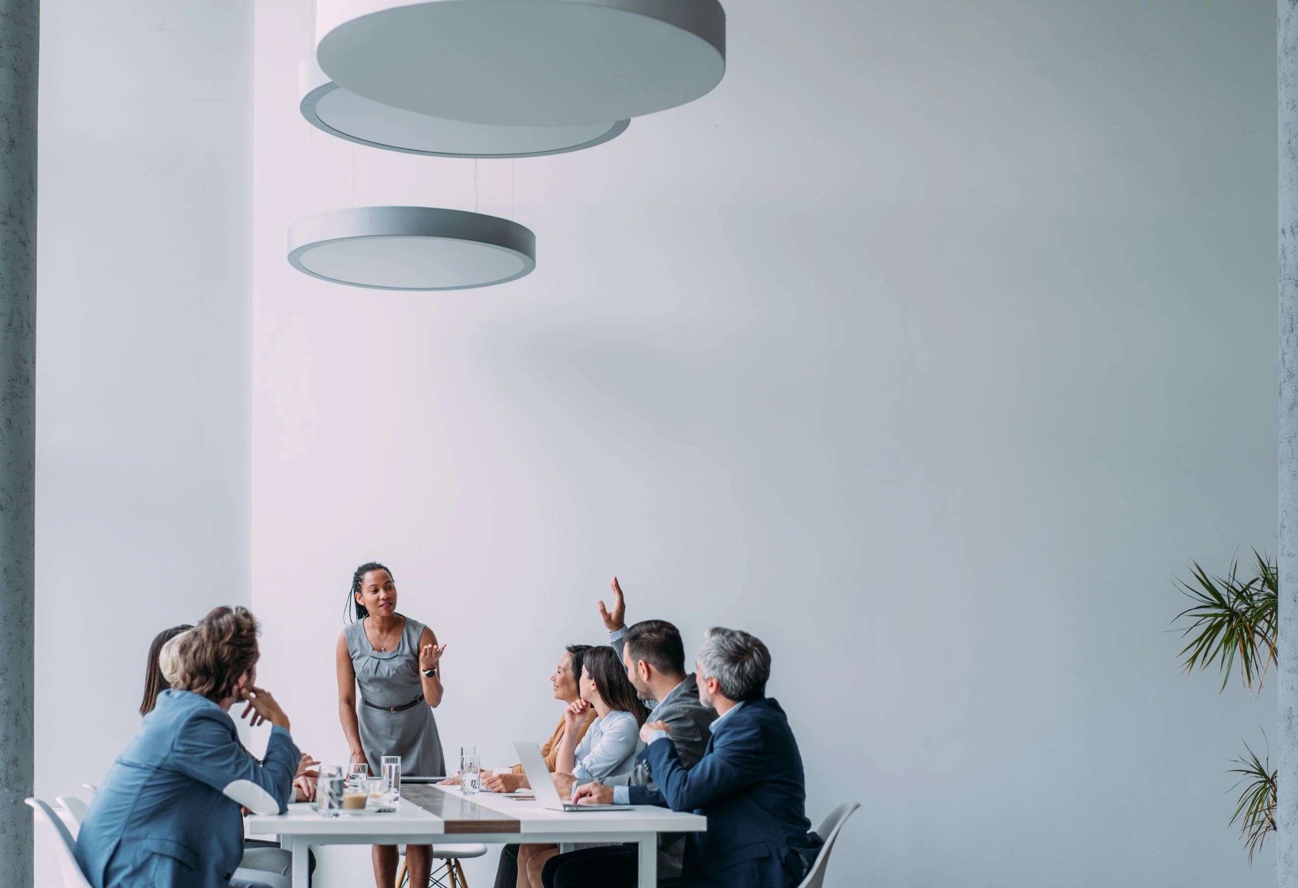 Consultant presenting strategy to a team in a boardroom