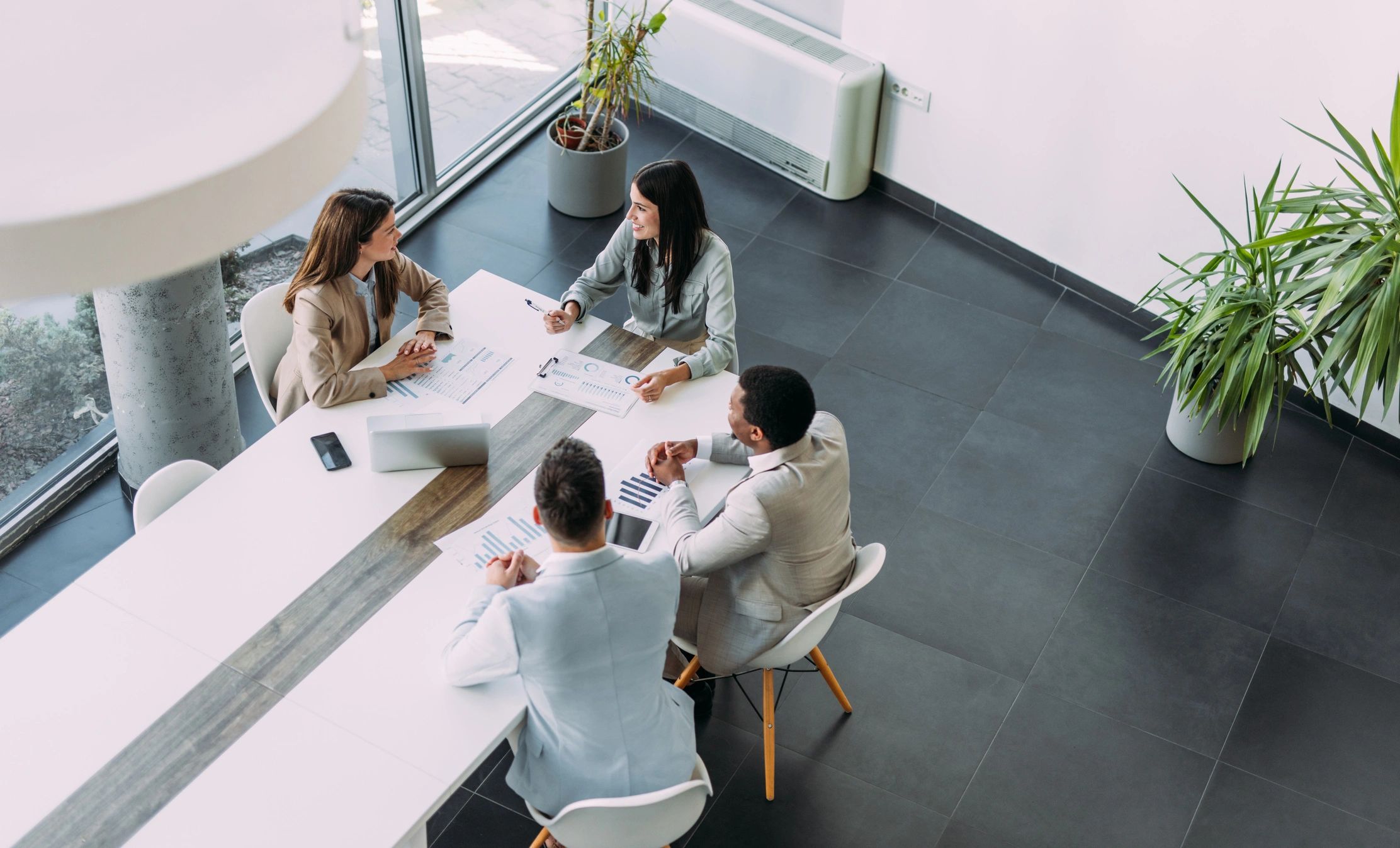 Consulting team gathered around a table in a strategy meeting